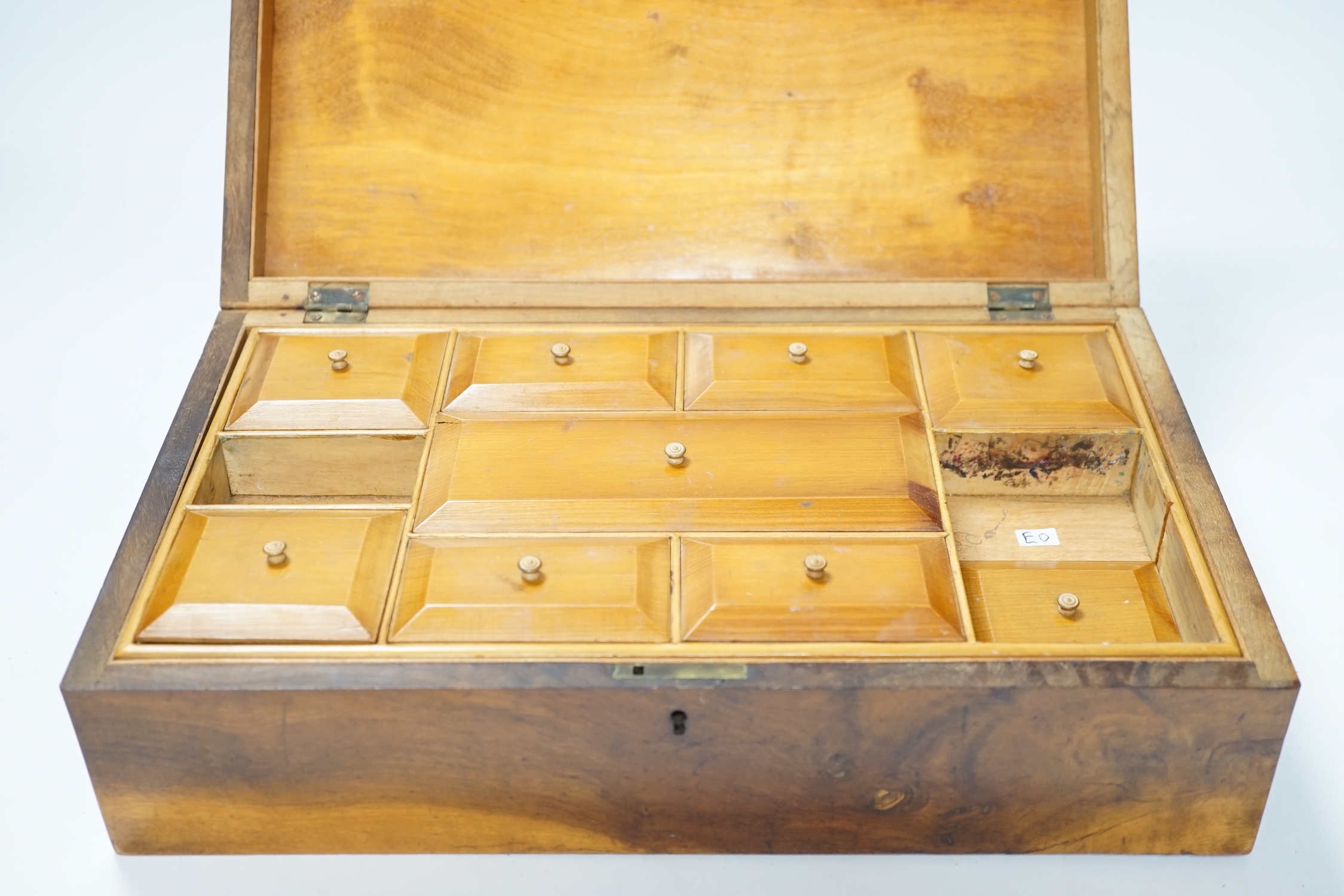 A late 19th century walnut sewing box, inlaid with a Napoleonic sea fort to a central cartouche on the lid and a fitted interior 33cm wide x10cm high